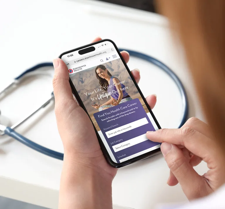 Healthcare professional viewing Eisenhower Health careers page on a mobile phone
